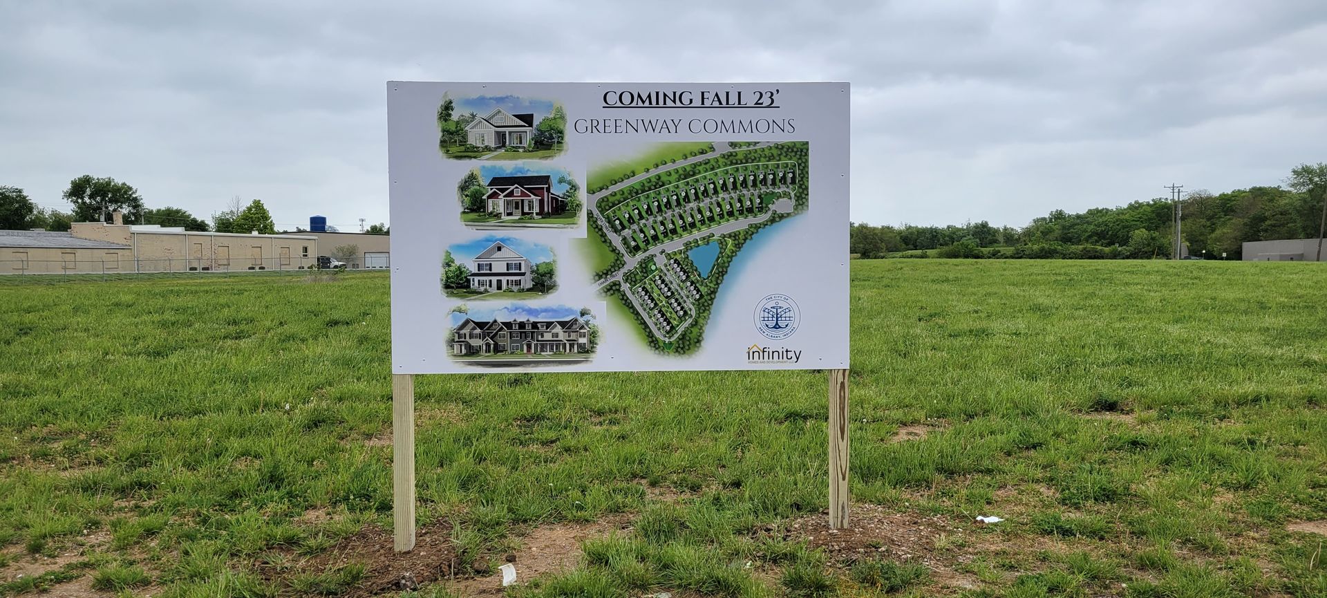 A sign is sitting in the middle of a grassy field.