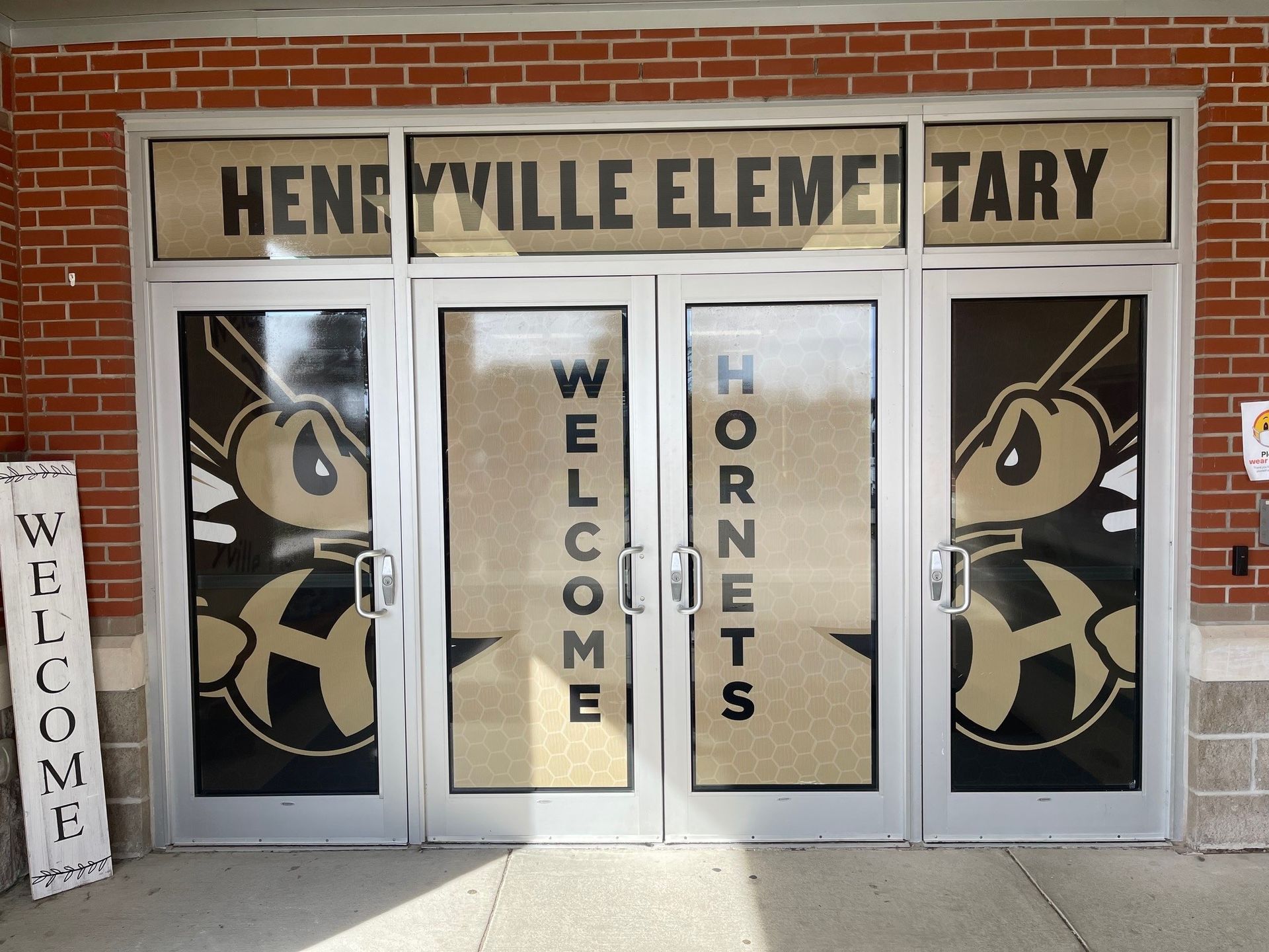 The entrance to henry ville elementary school with hornets on the doors