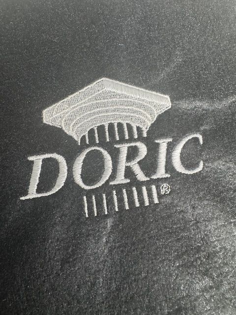 A black and white photo of a doric logo