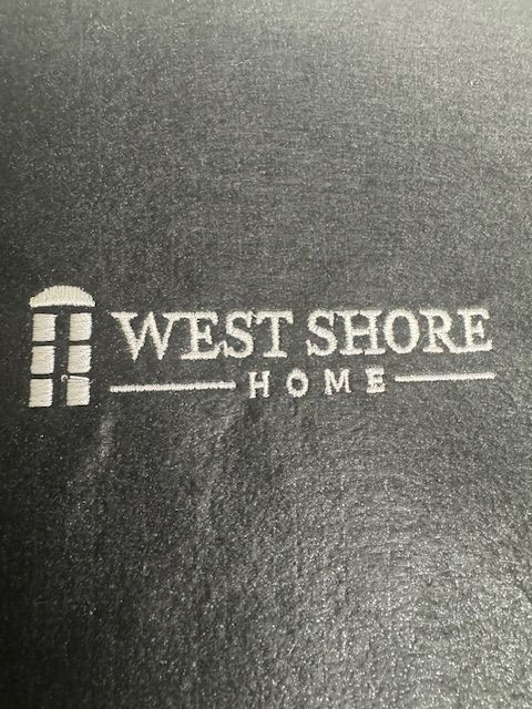 A west shore home logo on a black background