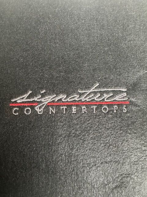 The word signature is on a black surface