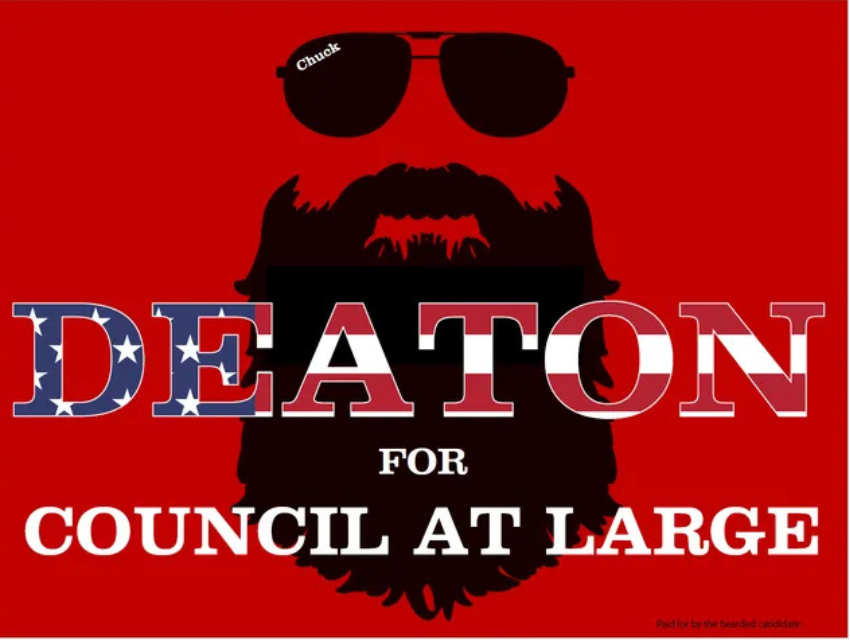 A poster that says deaton for council at large