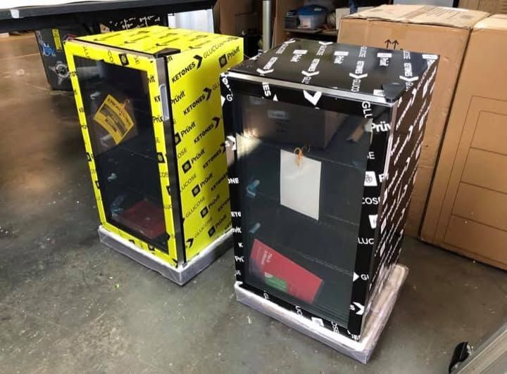 Two black and yellow boxes are sitting next to each other