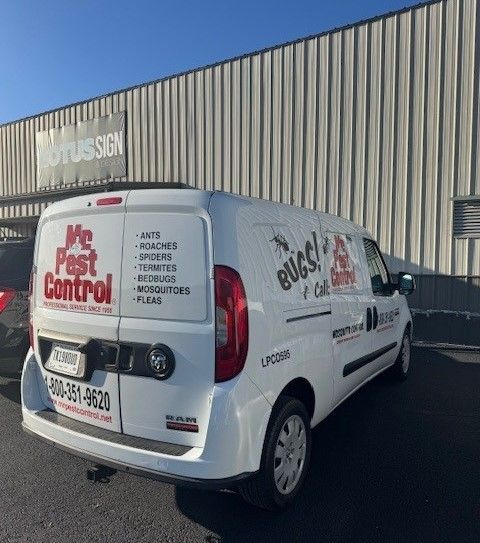 A white van that says we pest control is parked in front of a building.
