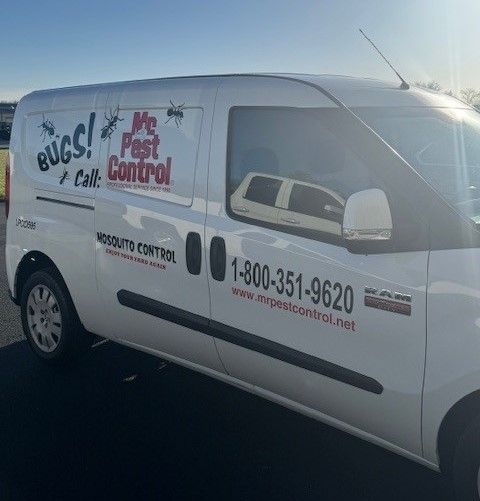 A white van is parked on the side of the road.