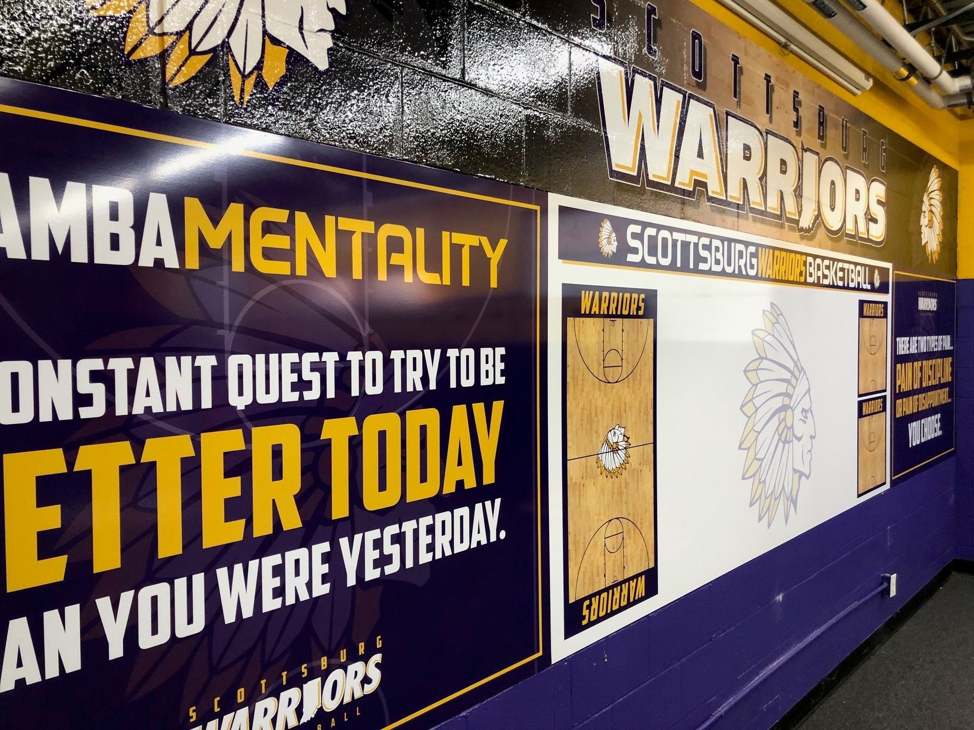A sign on a wall that says warriors on it