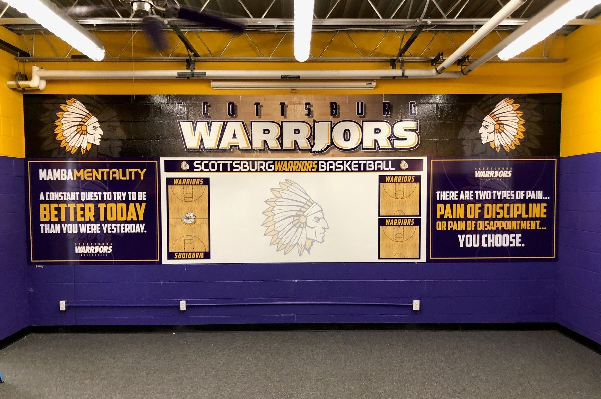 A purple wall with warriors written on it