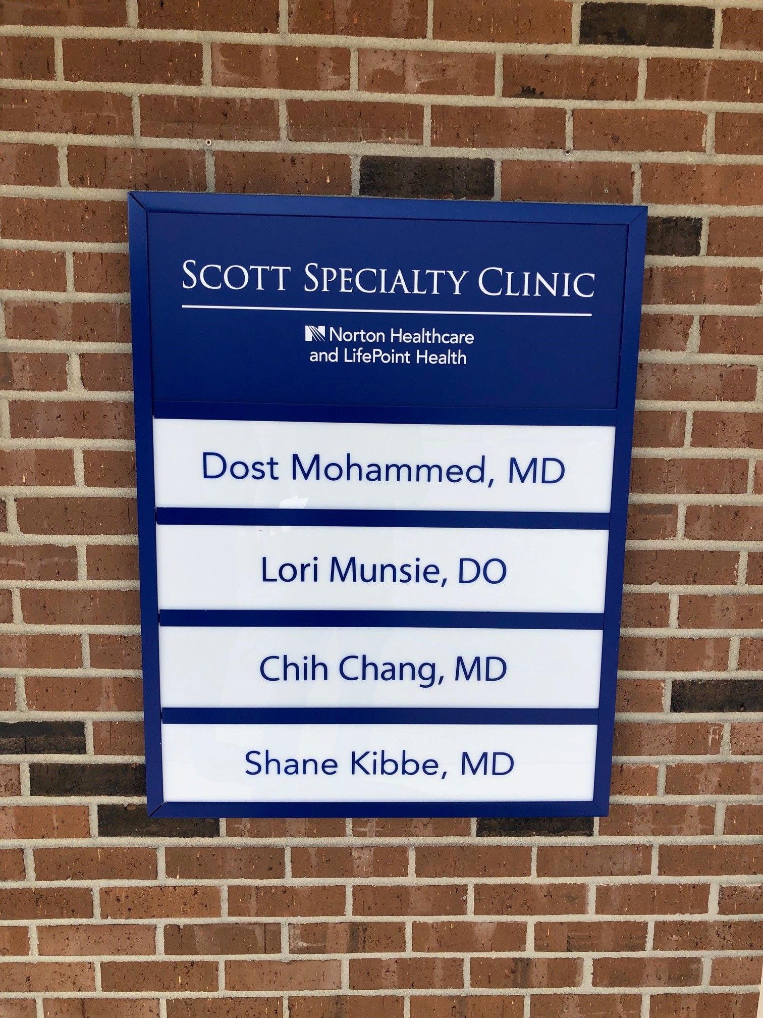 A scott specialty clinic sign on a brick wall