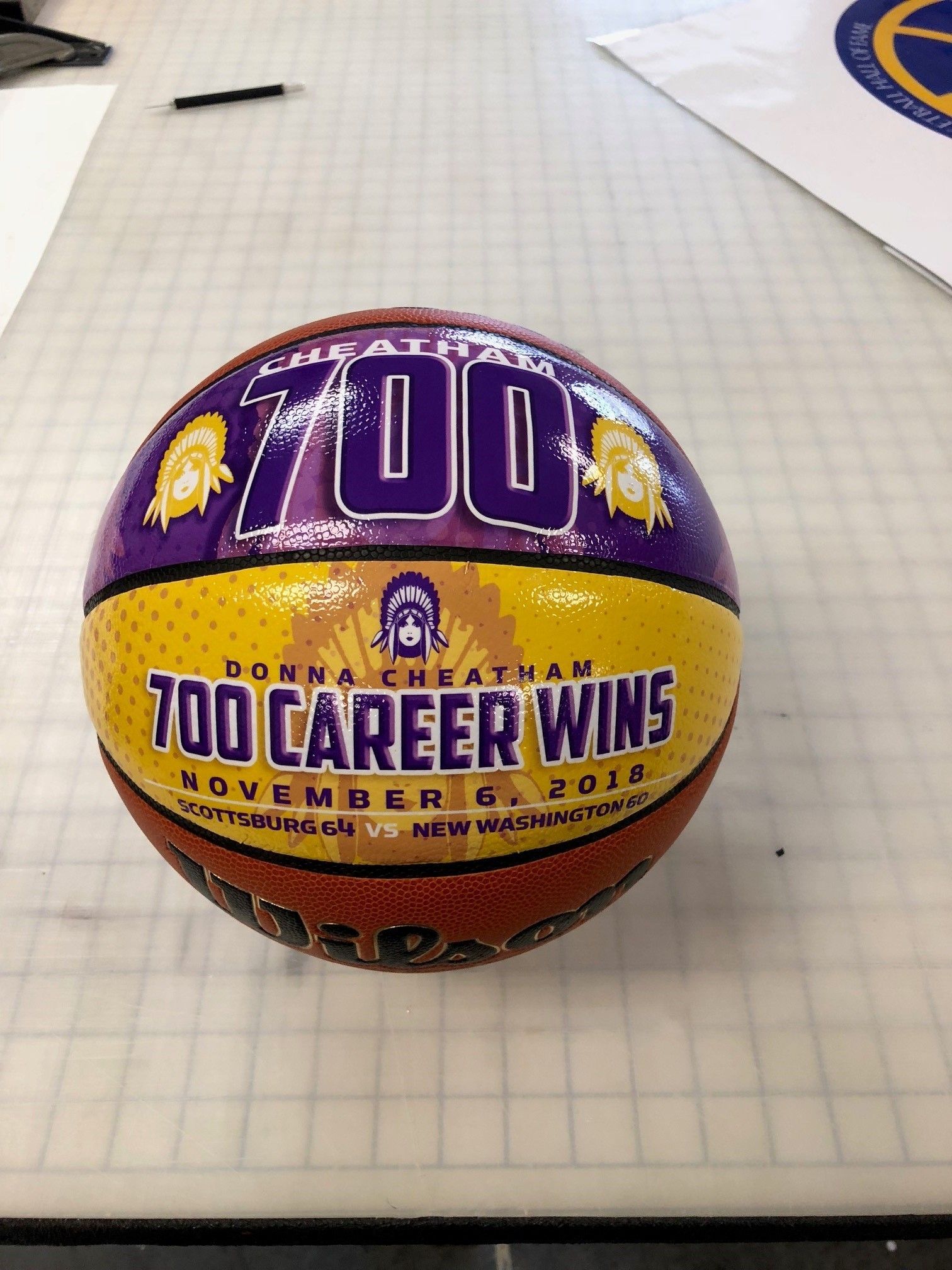 A basketball that says 700 career wins on it