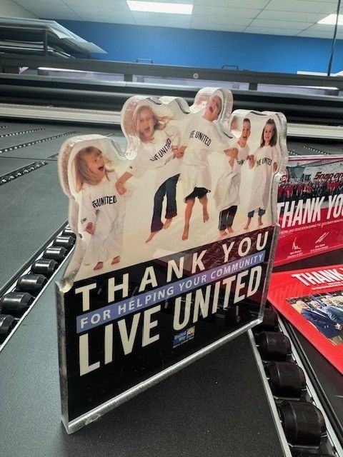 A sign that says thank you for helping your community live united