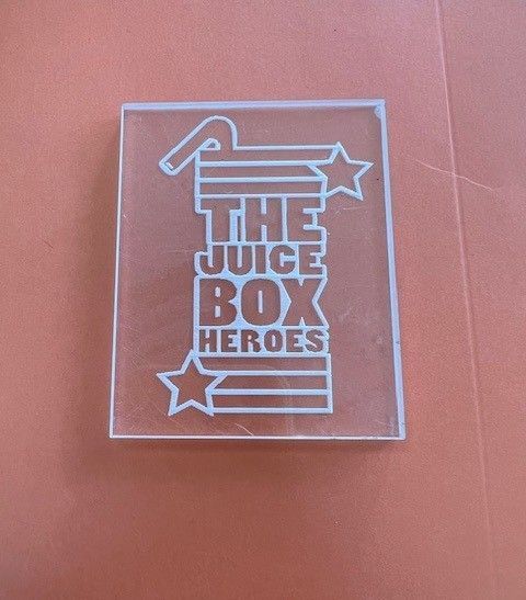 A clear box that says the juice box heroes
