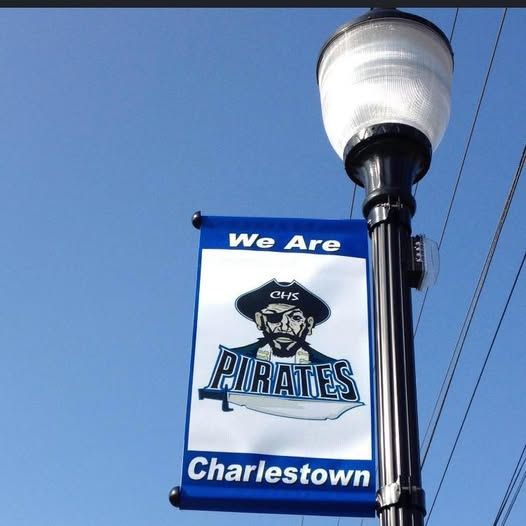A street light with a banner that says we are pirates charlestown