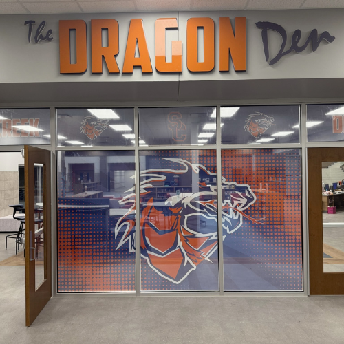 A building with a sign that says the dragon den