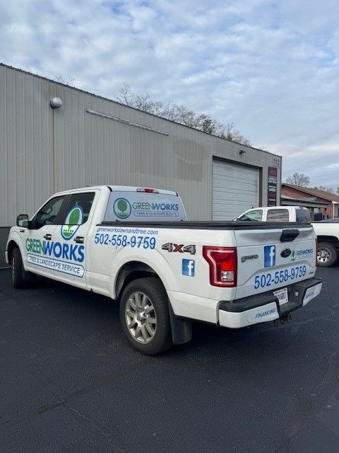 A white truck is parked in front of a building.