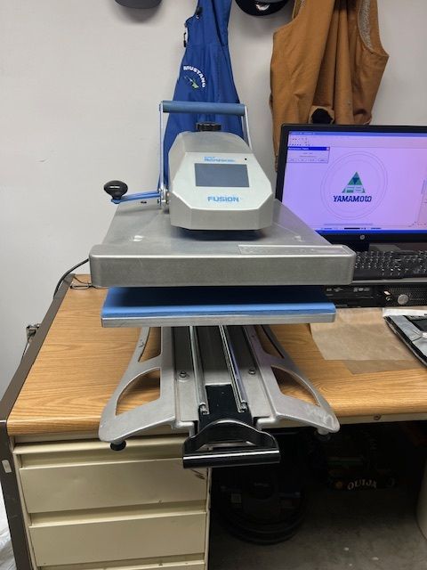 A machine is sitting on a desk next to a computer