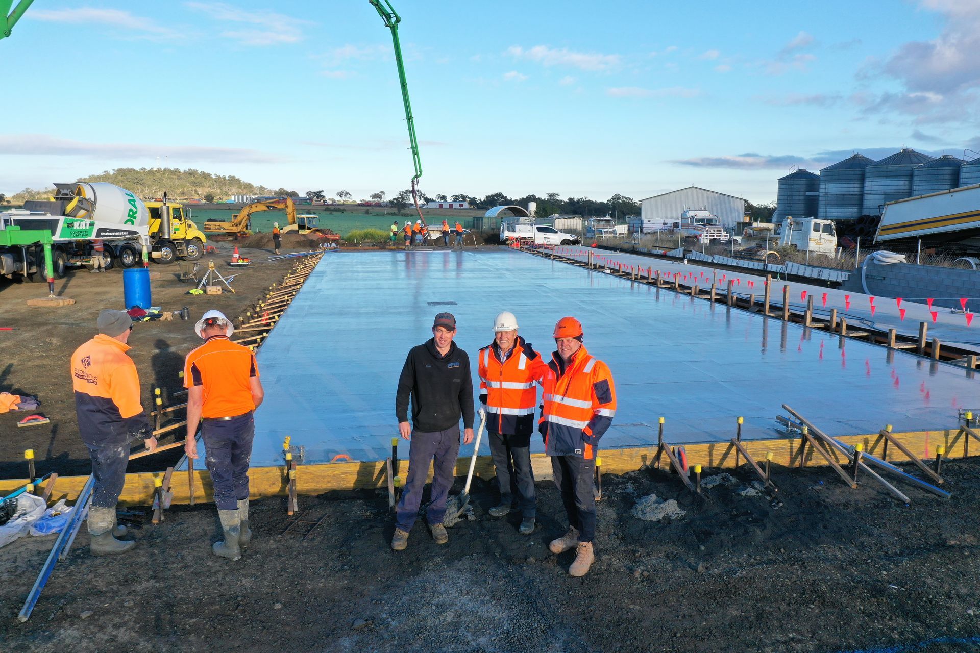Construction Workers Concrete Pouring During Commercial Concreting Floors — CR Concreting in Pittsworth, QLD