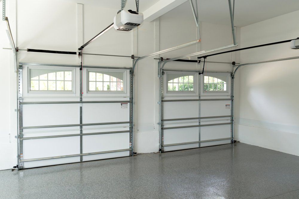 An Empty Garage With Two Garage Doors and a Garage Door Opener — C R Concreting in Dalby, QLD