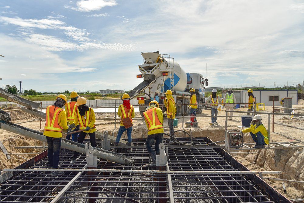 A Group of Construction Workers are Working on a Construction Site — C R Concreting in Gatton, QLD