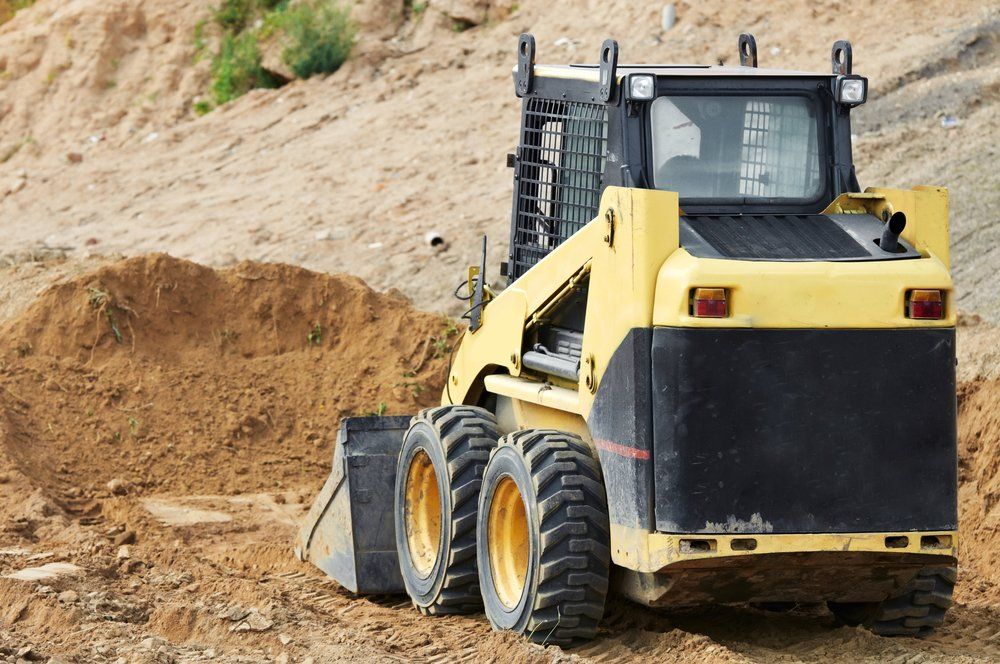 Skid Steer Loader Moving Sand Soil At Construction Area Outdoors — CR Concreting in Pittsworth, QLD