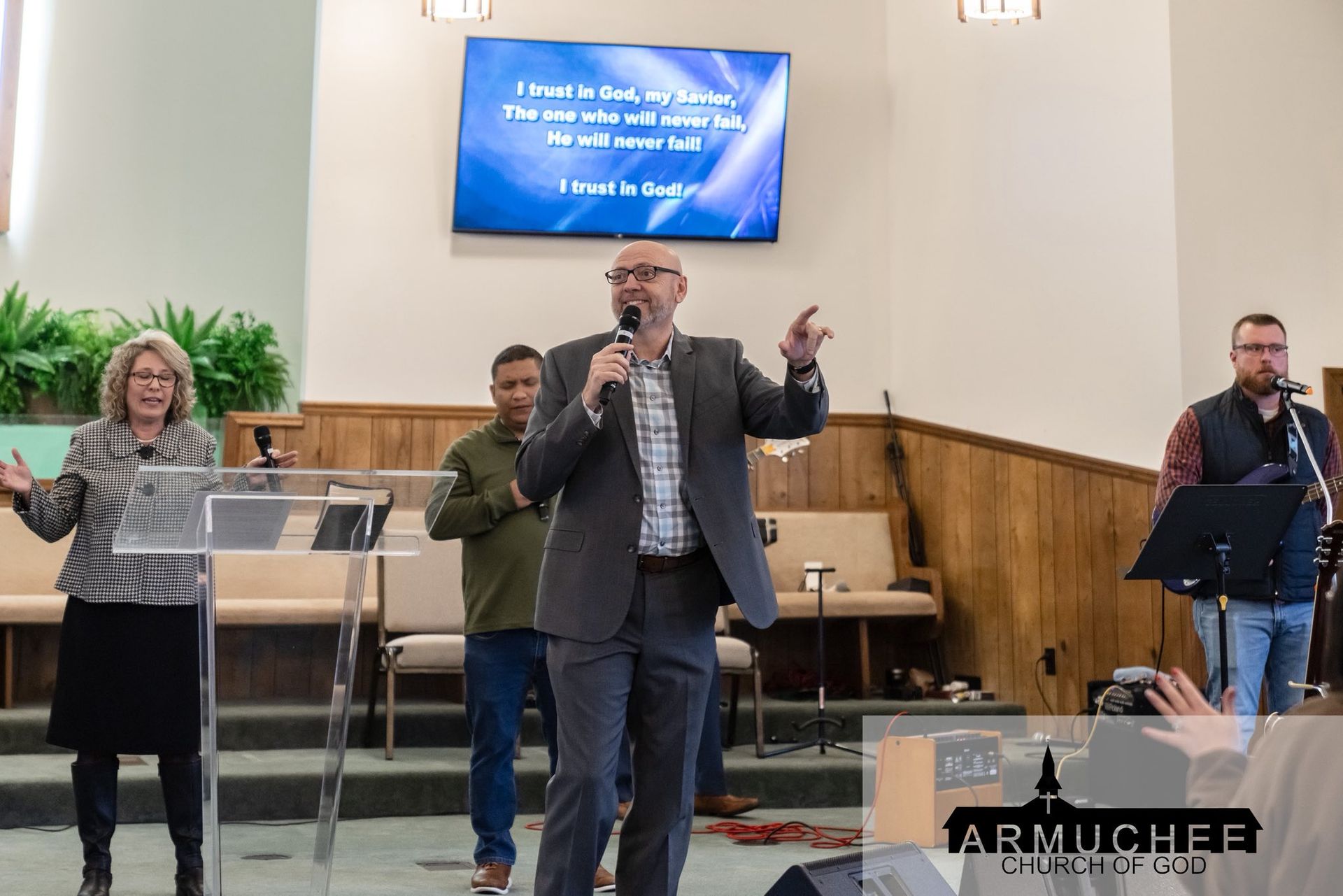 Armuchee Church of God -A group of people are raising their hands in the air in a room.