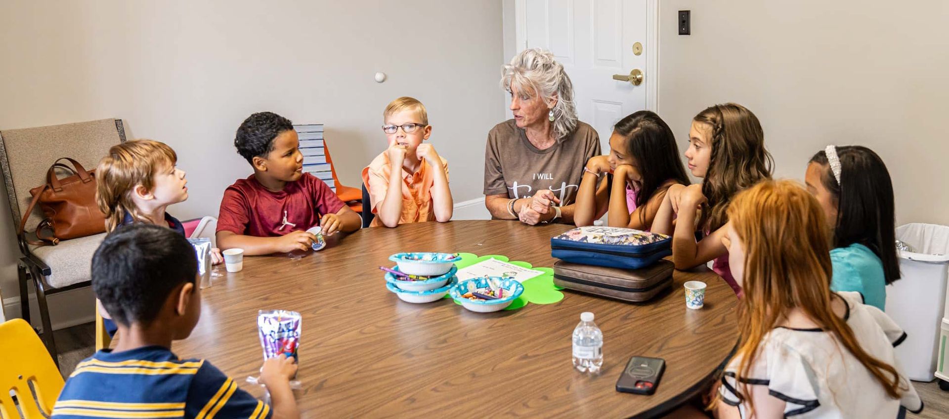 Armuchee Church of God -A group of children are sitting around a table with a woman.