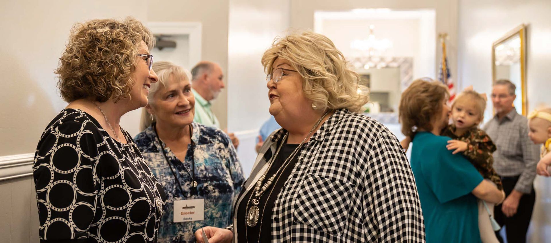 Armuchee Church of God -A group of women are standing in a room talking to each other.