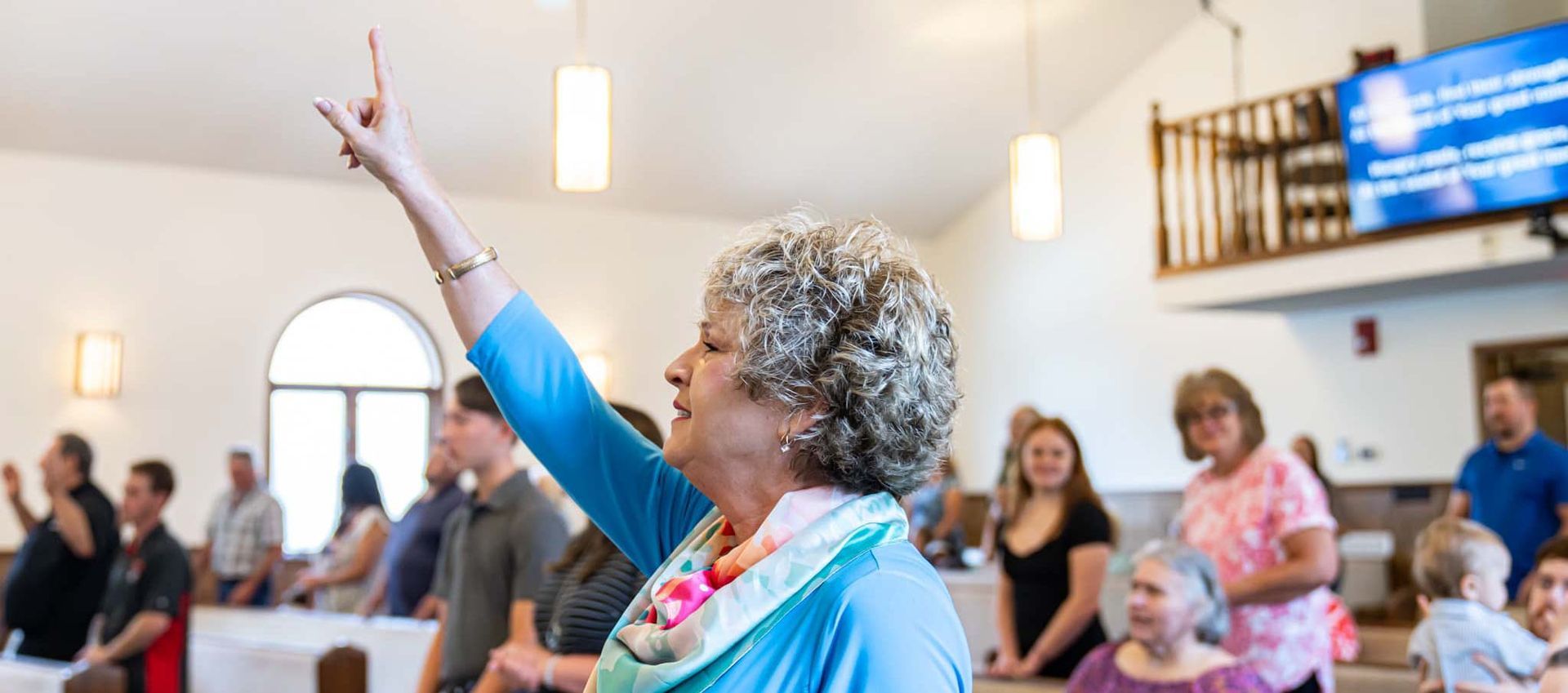 Armuchee Church of God -A woman is giving a speech in front of a crowd of people in a church.