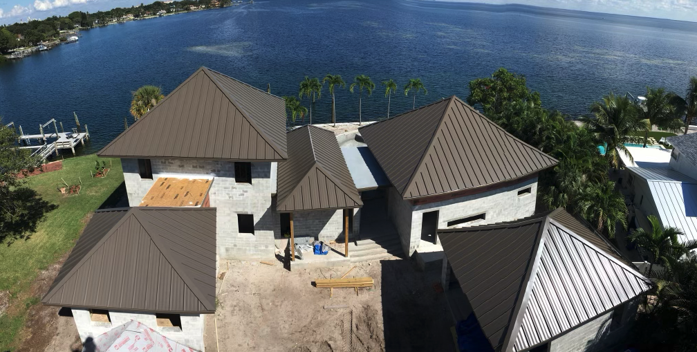 Completed waterproofed metal roof reflecting sunlight in Central Florida