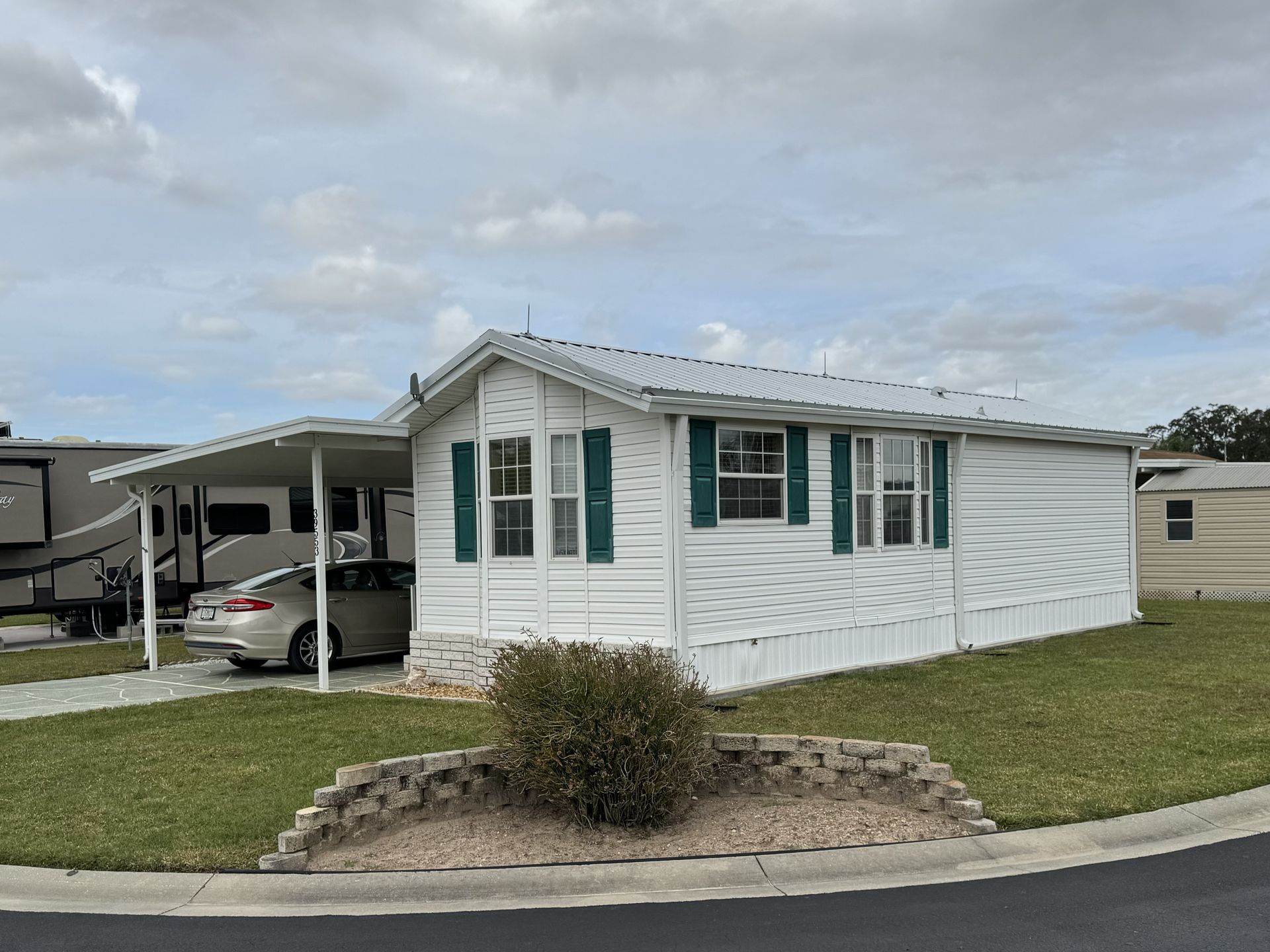 A happy homeowner enjoying a quiet, comfortable home with a noise-reduced metal roof.