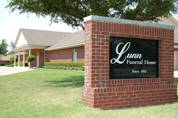 Lunn Funeral Home sign in front of a brick building.