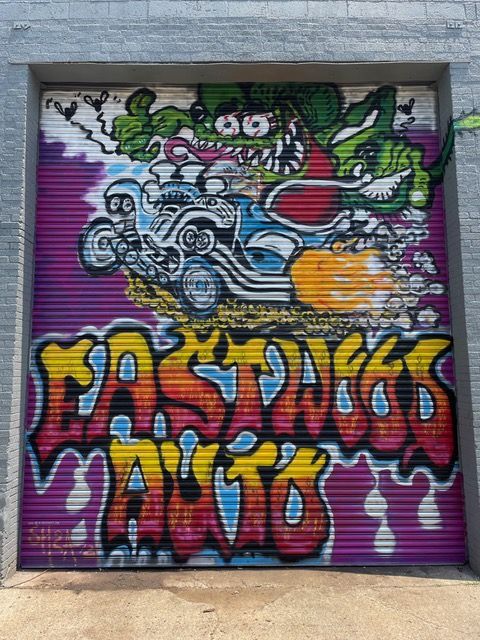 A brightly colored mural of Eastwood Auto