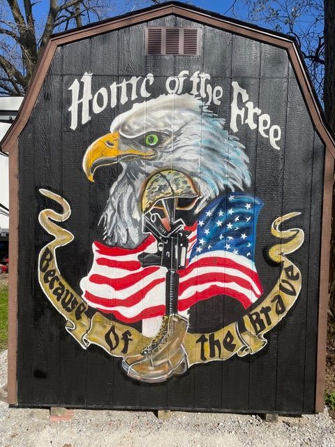 A mural of an eagle and American flag on a shed