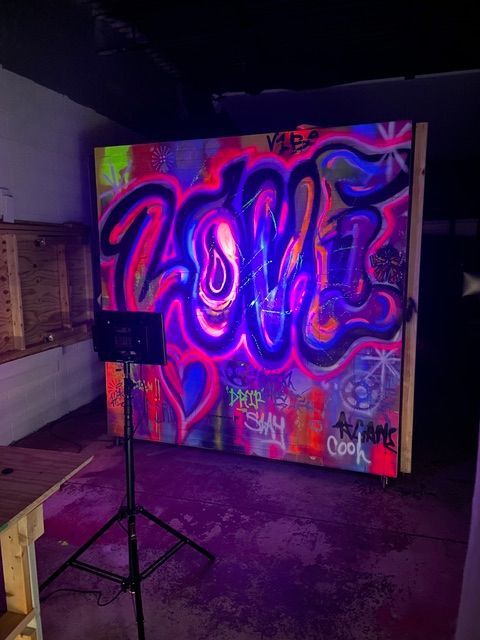 A mural painted on a wall with bright colors pink and purple