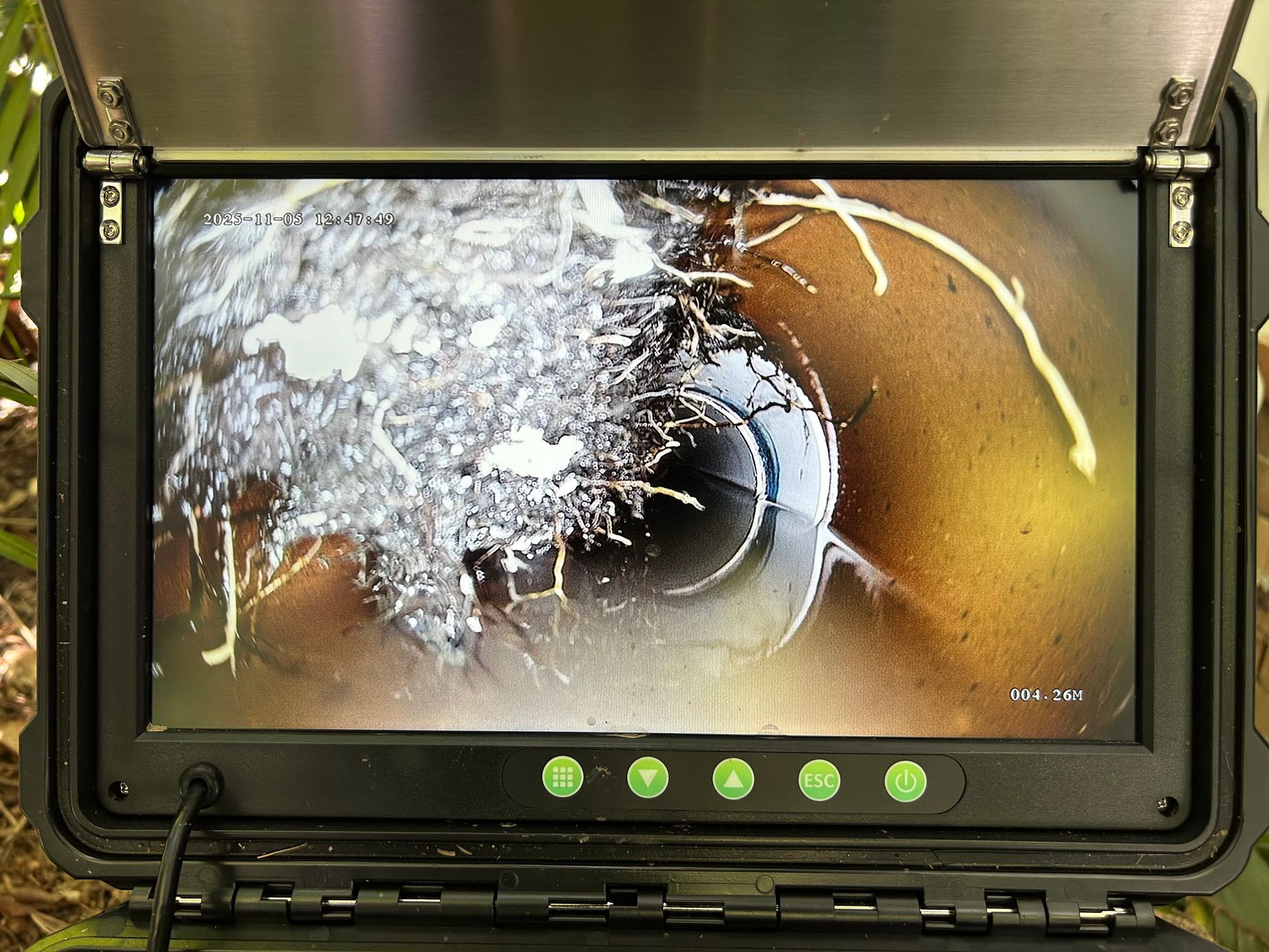 Monitor showing a close-up of a pipe interior. Roots and debris are blocking the view — No. 2 Plumbing In Kenmore, QLD