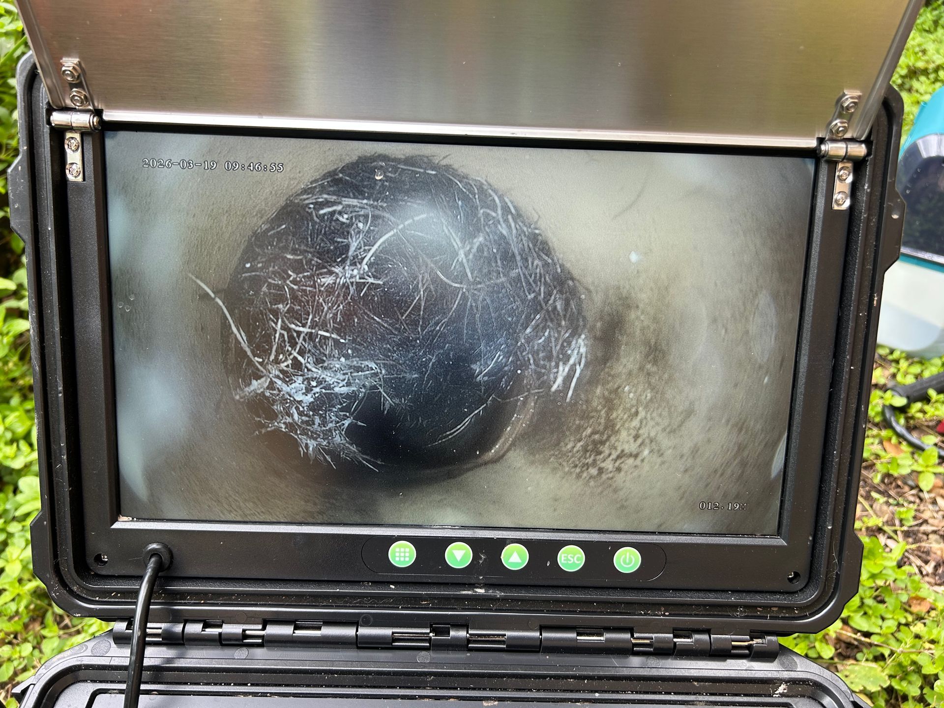 A sewer camera monitor displays a dark, circular pipe interior showing tree roots intruding through a joint — No. 2 Plumbing In Toowong, QLD