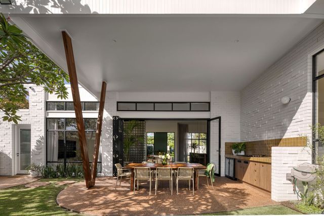 A patio with a table and chairs under a canopy