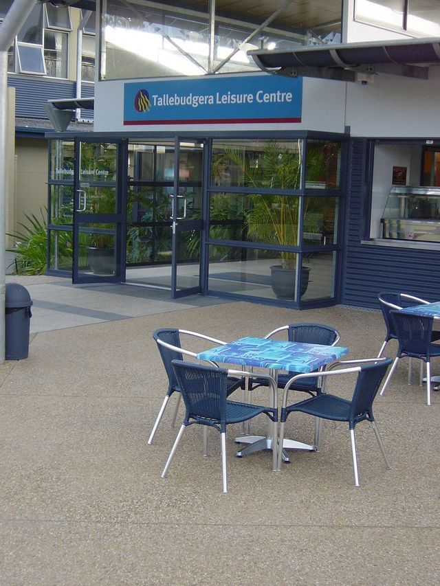 Tables and chairs in front of a building that says leisure centre