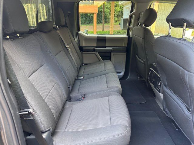 The rear seats of a ford f150 truck are empty.
