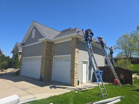 An aerial view of a small house with a red metal roof.