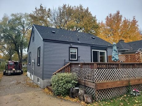 A large house with a lot of windows is surrounded by trees.