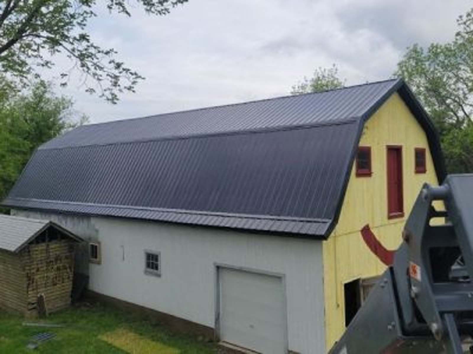 A barn with a smiley face painted on it