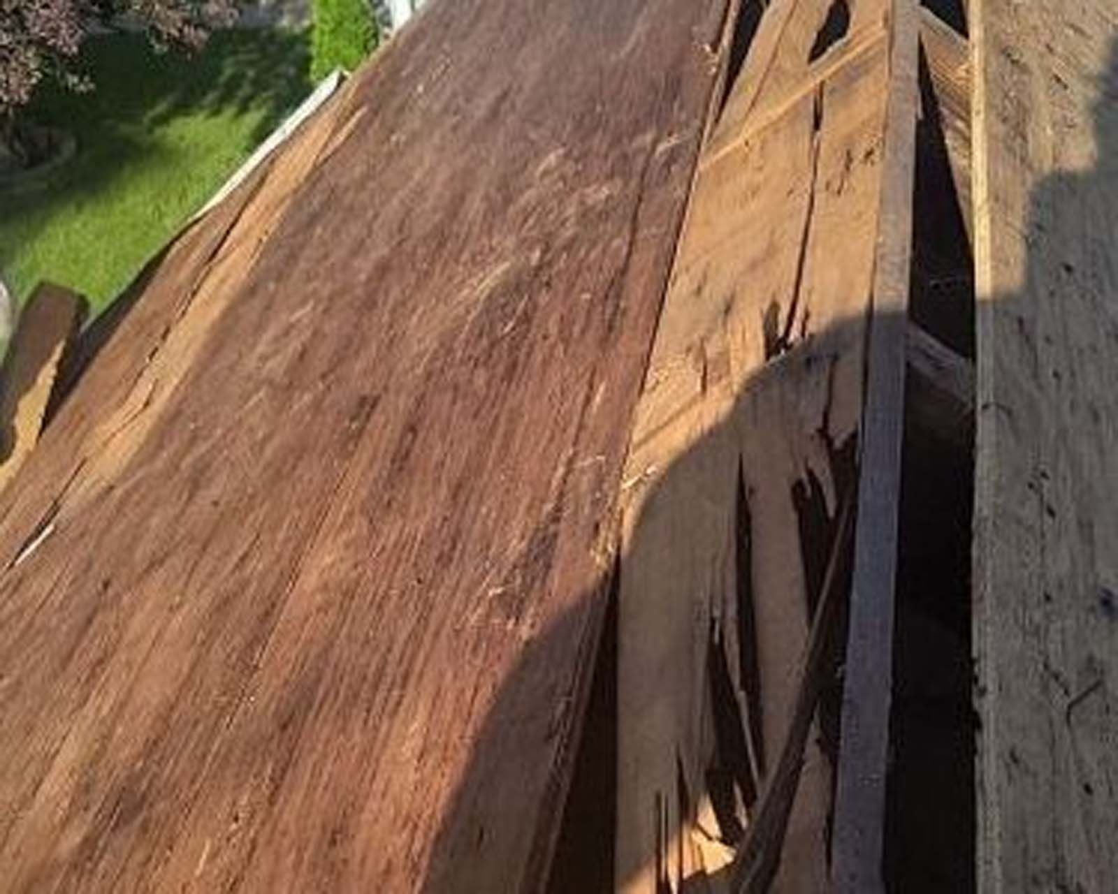 A wooden roof with a lot of pieces of wood on it.