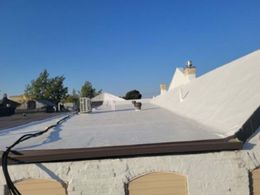 A white roof with a blue sky in the background.