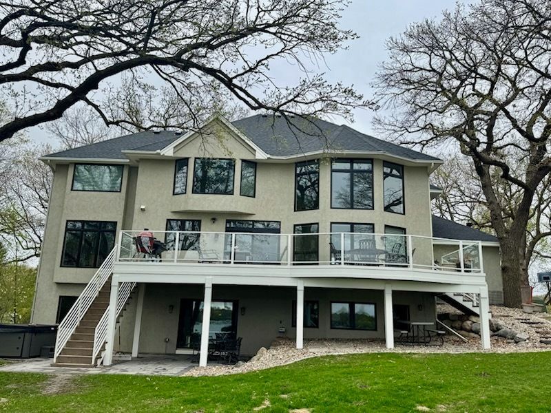 A large house with a large deck and stairs