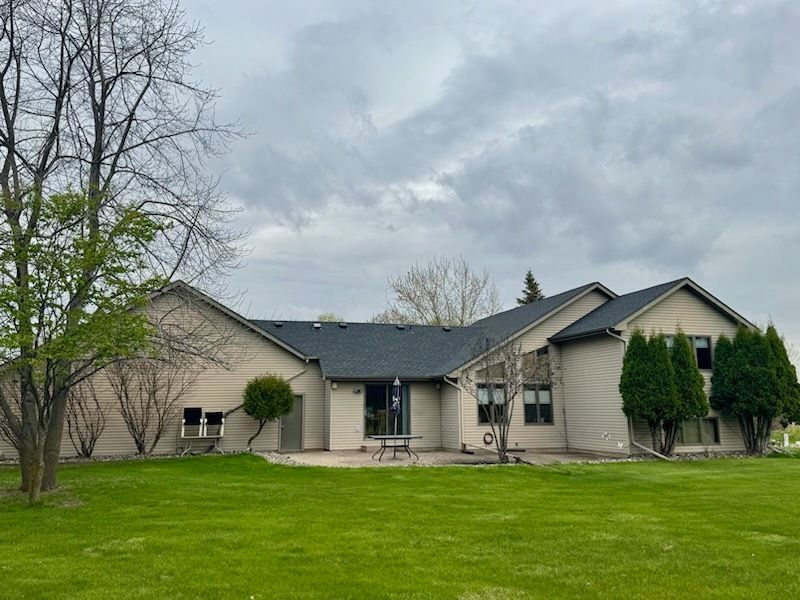A large house with a large lawn in front of it.