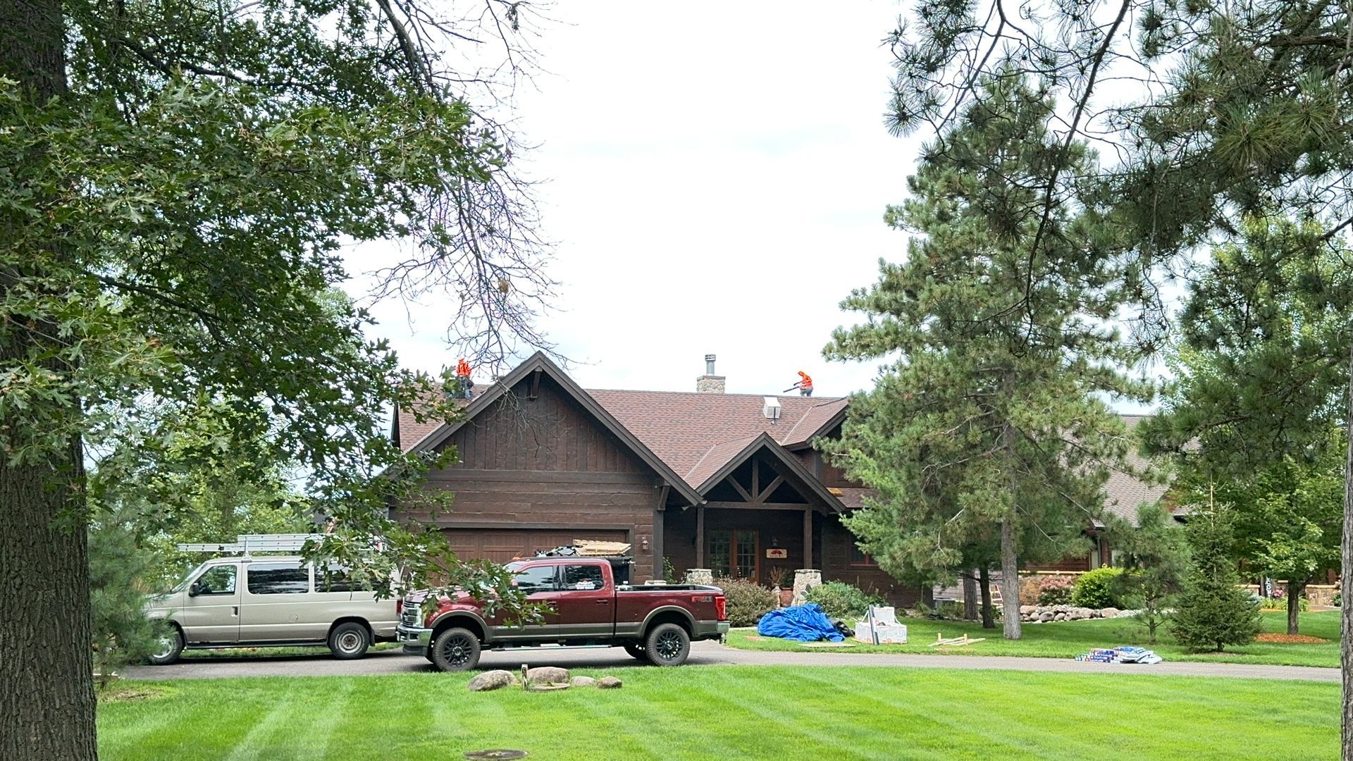 A red truck is parked in front of a house.