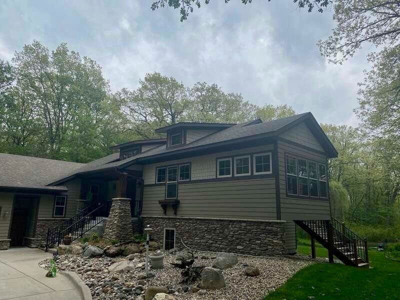 A large house with a lot of windows and trees in the background.