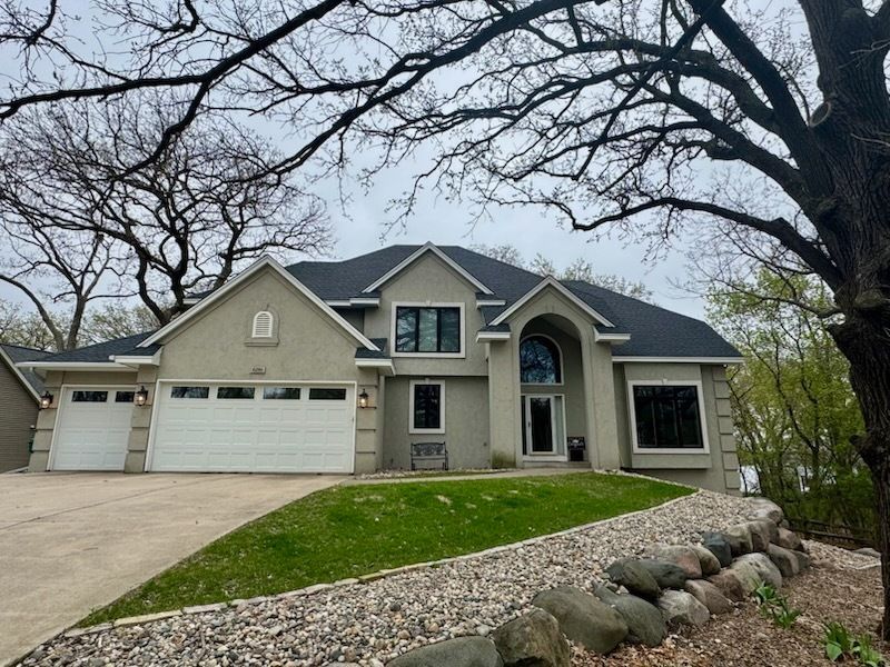 A large house with a tree in front of it
