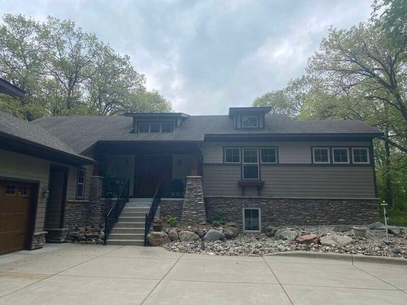 A large house with a lot of windows and a driveway in front of it.