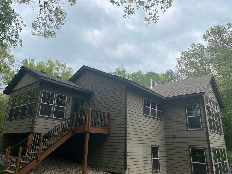 A large house with a large deck and stairs